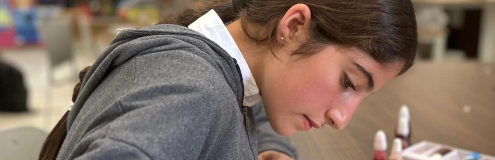 A student making a glass painting.